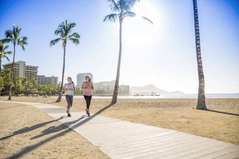 Two women jogging by the beach