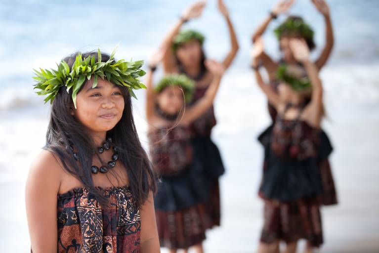 young girls dressed in hula attire on beach