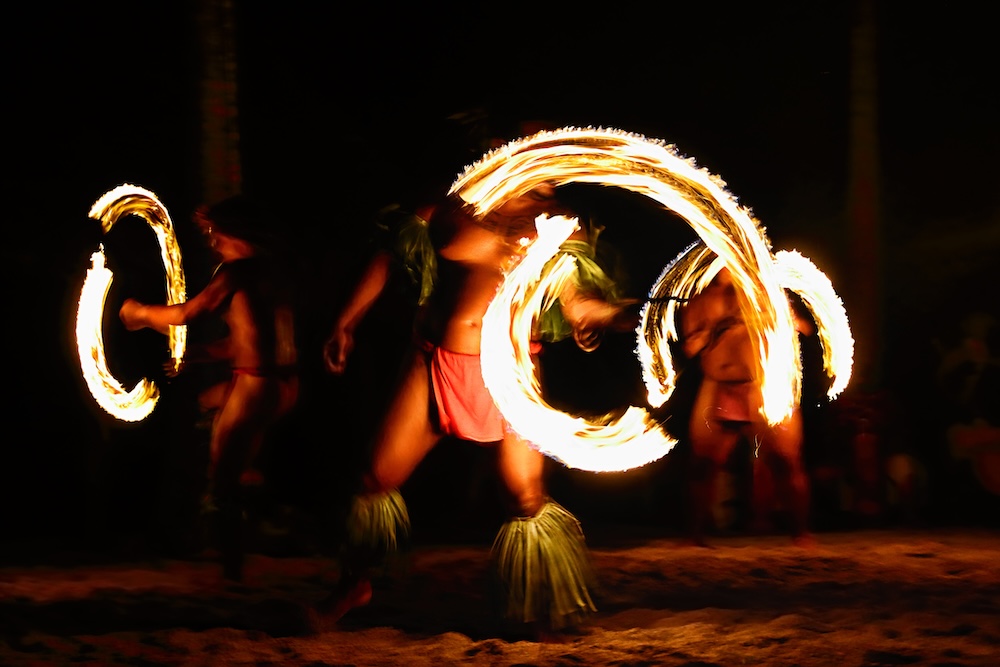 Men dancing hula with fire